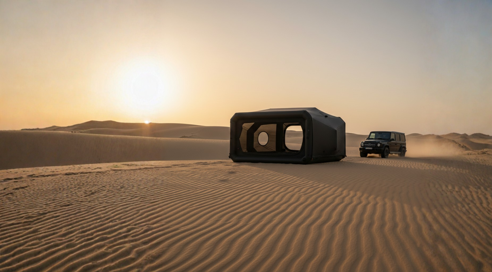 Desert landscape with a large black rectangular object and a vehicle in the distance.